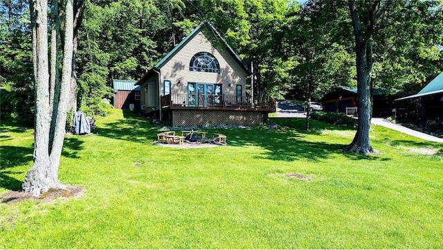 W6741 Lakewood Blvd, Ladysmith, WI 54848 - back of house with a wooden deck, a lawn, and an outdoor fire pit