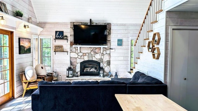 W6741 Lakewood Blvd, Ladysmith, WI 54848 - living area featuring stairway, wooden walls, a stone fireplace, and wood finished floors