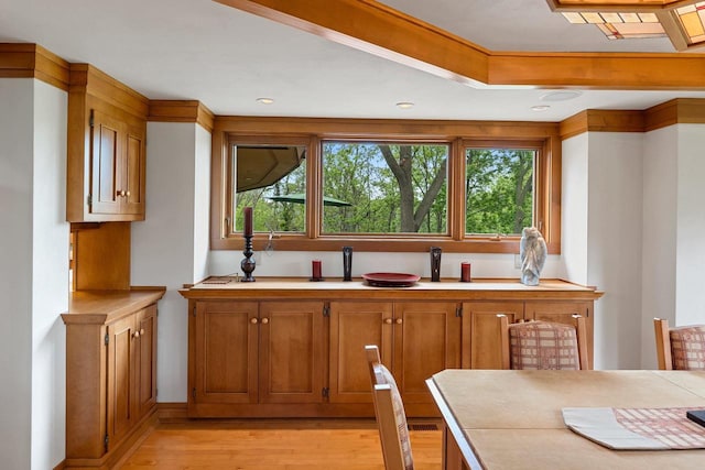 1225 W Cedar St, Appleton, WI 54914 - kitchen with light wood-type flooring, light countertops, brown cabinetry, and recessed lighting