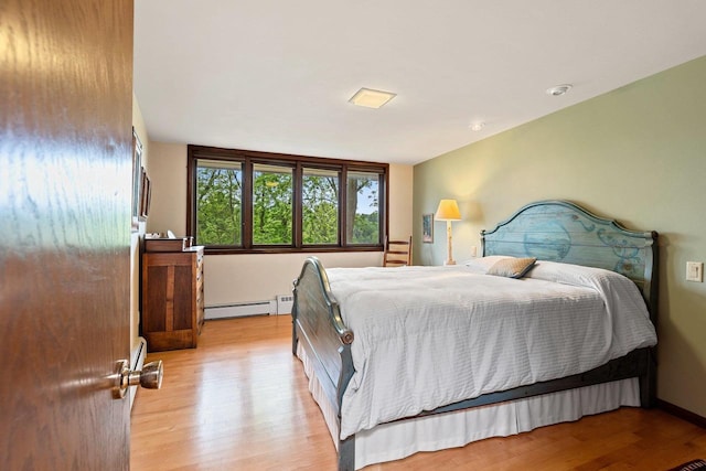 1225 W Cedar St, Appleton, WI 54914 - bedroom with a baseboard heating unit and light wood-type flooring