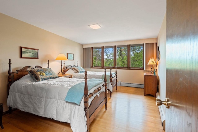 1225 W Cedar St, Appleton, WI 54914 - bedroom with a baseboard heating unit and light wood-type flooring
