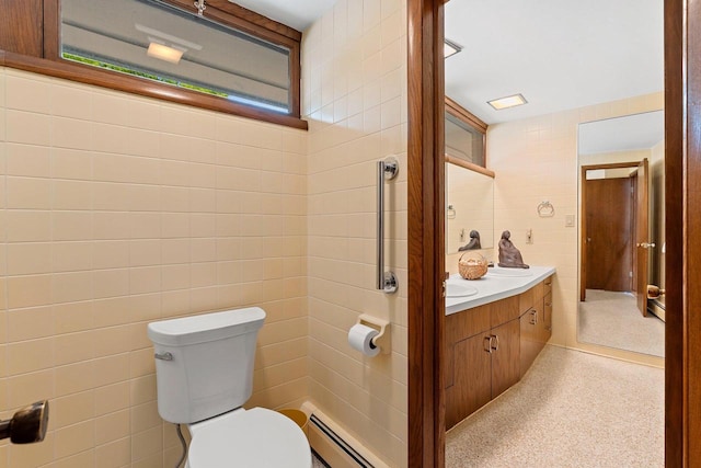 1225 W Cedar St, Appleton, WI 54914 - bathroom featuring tile walls, a baseboard heating unit, and vanity