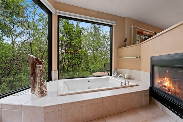 1225 W Cedar St, Appleton, WI 54914 - full bathroom with a tiled fireplace, a tub with jets, and tile patterned floors