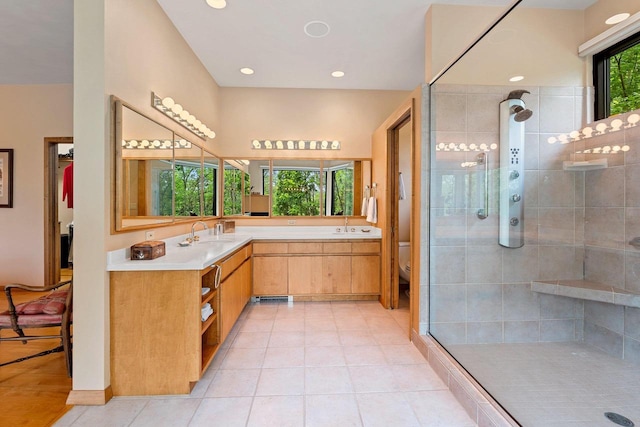 1225 W Cedar St, Appleton, WI 54914 - bathroom featuring a tile shower, double vanity, tile patterned floors, and recessed lighting
