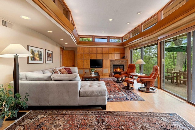 1225 W Cedar St, Appleton, WI 54914 - living area featuring wood finished floors, a glass covered fireplace, and recessed lighting