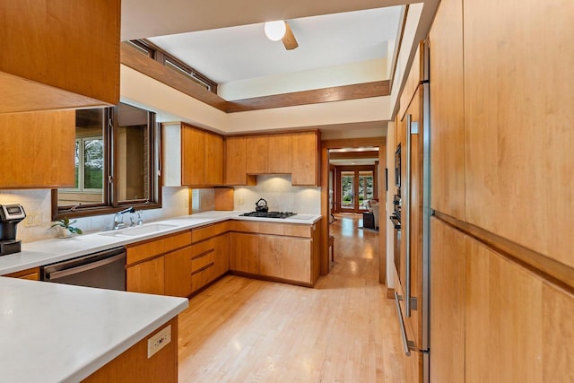 1225 W Cedar St, Appleton, WI 54914 - kitchen featuring stainless steel dishwasher, plenty of natural light, decorative backsplash, and light wood-style floors