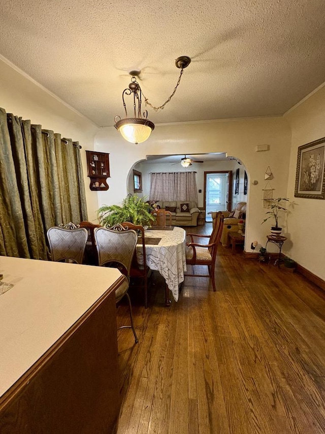 4110 N 7th St, Milwaukee, WI 53209 - dining room featuring arched walkways, wood finished floors, a textured ceiling, and ornamental molding