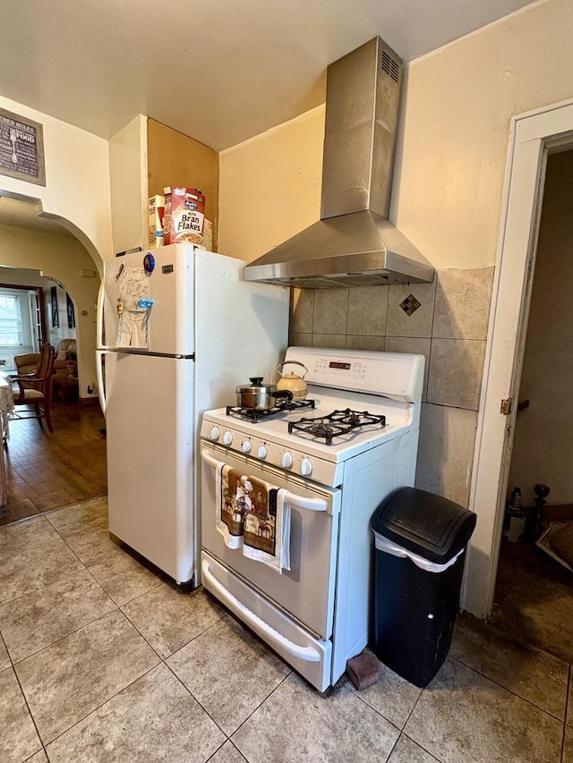 4110 N 7th St, Milwaukee, WI 53209 - kitchen with gas range gas stove, island exhaust hood, arched walkways, and light tile patterned flooring