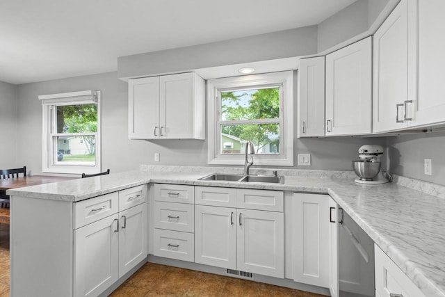 931 W Lindbergh St, Appleton, WI 54914 - kitchen featuring a peninsula, white cabinetry, stainless steel dishwasher, and light stone countertops