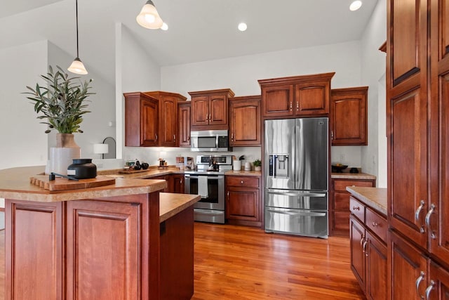 52 Penbrook Cir Unit 47, Appleton, WI 54911 - kitchen with appliances with stainless steel finishes, a peninsula, hanging light fixtures, wood finished floors, and recessed lighting