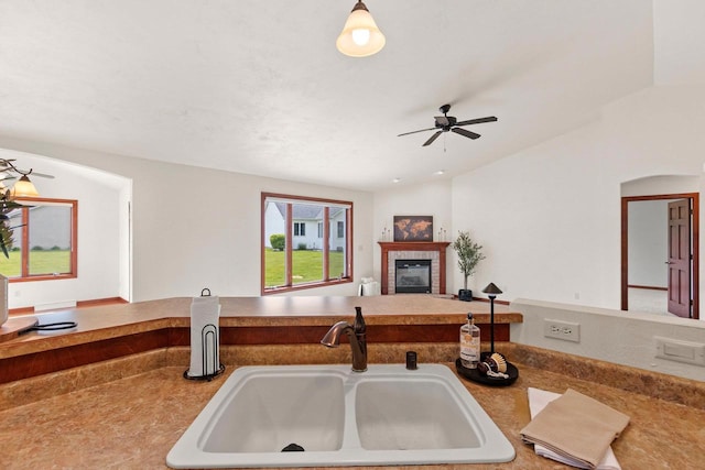 52 Penbrook Cir Unit 47, Appleton, WI 54911 - kitchen featuring a tiled fireplace, a ceiling fan, and open floor plan
