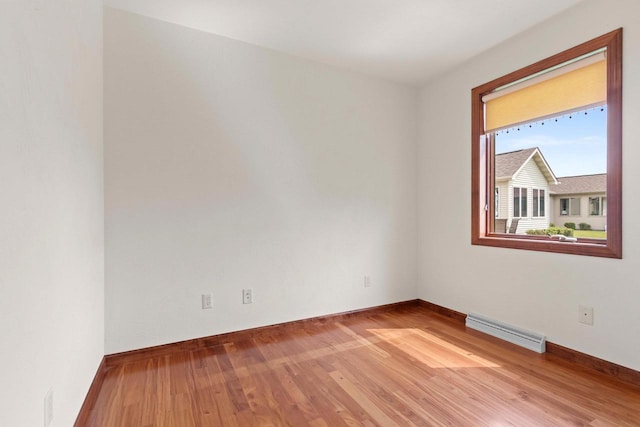 52 Penbrook Cir Unit 47, Appleton, WI 54911 - empty room featuring wood finished floors and a baseboard heating unit