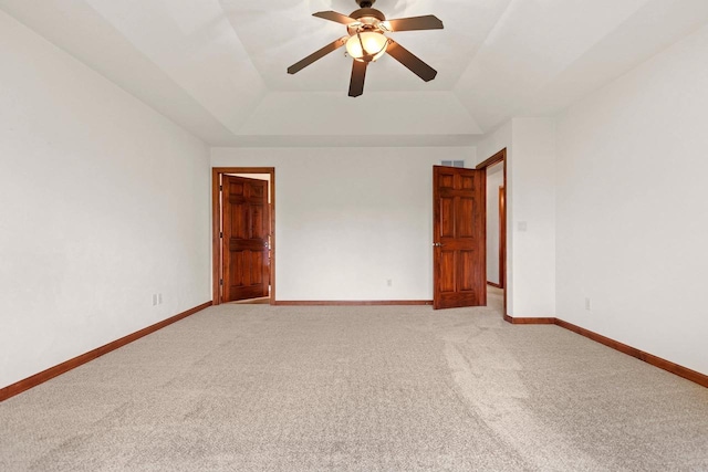 52 Penbrook Cir Unit 47, Appleton, WI 54911 - empty room featuring a raised ceiling, light colored carpet, and a ceiling fan