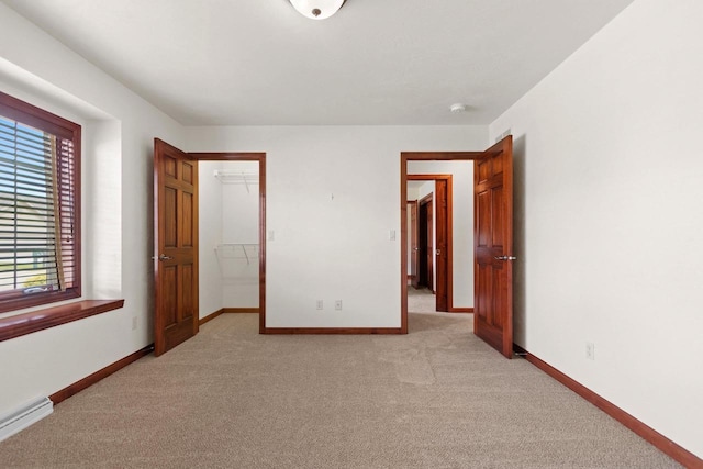 52 Penbrook Cir Unit 47, Appleton, WI 54911 - unfurnished bedroom featuring light colored carpet, baseboard heating, a walk in closet, and a closet