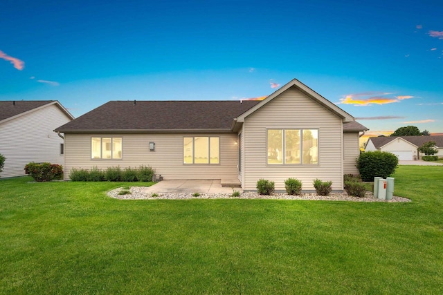 52 Penbrook Cir Unit 47, Appleton, WI 54911 - back of house featuring a yard, a patio area, and roof with shingles