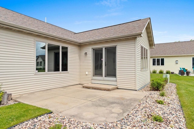 52 Penbrook Cir Unit 47, Appleton, WI 54911 - rear view of house with a shingled roof, a patio area, and a lawn