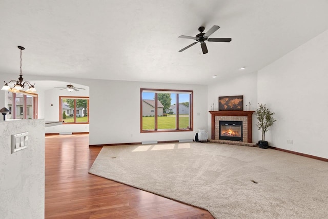52 Penbrook Cir Unit 47, Appleton, WI 54911 - unfurnished living room with ceiling fan, a chandelier, a brick fireplace, and wood finished floors