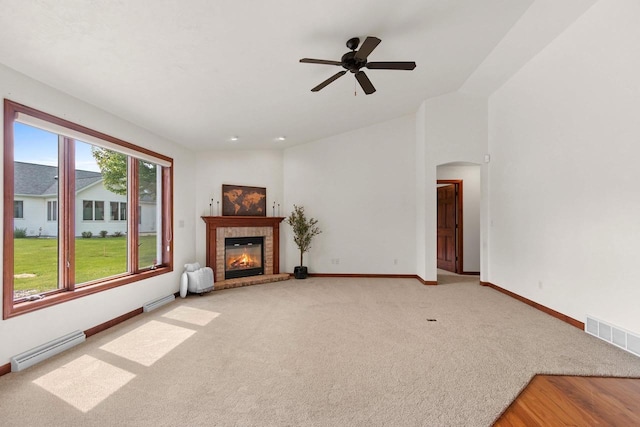 52 Penbrook Cir Unit 47, Appleton, WI 54911 - unfurnished living room featuring carpet, a baseboard radiator, ceiling fan, a brick fireplace, and arched walkways