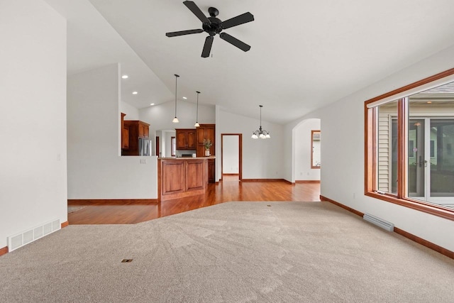 52 Penbrook Cir Unit 47, Appleton, WI 54911 - unfurnished living room featuring lofted ceiling, ceiling fan, arched walkways, light carpet, and recessed lighting