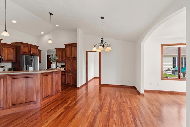 52 Penbrook Cir Unit 47, Appleton, WI 54911 - kitchen featuring stainless steel appliances, lofted ceiling, arched walkways, light wood finished floors, and recessed lighting