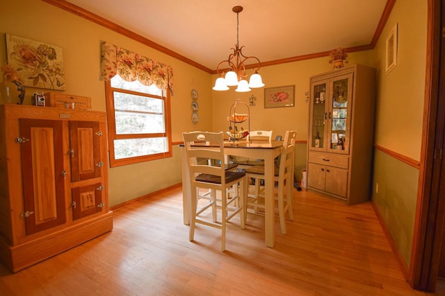 1135 W Walworth Ave, Whitewater, WI 53190 - dining space with a chandelier, crown molding, and light wood-type flooring