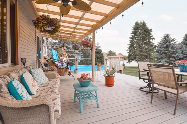 1135 W Walworth Ave, Whitewater, WI 53190 - deck featuring outdoor dining area, a ceiling fan, and an outdoor pool