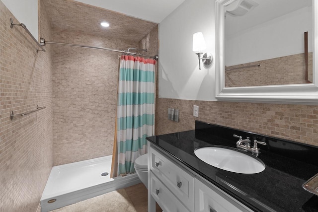8823 406th Ave, Genoa City, WI 53128 - bathroom featuring a tile shower, vanity, and decorative backsplash