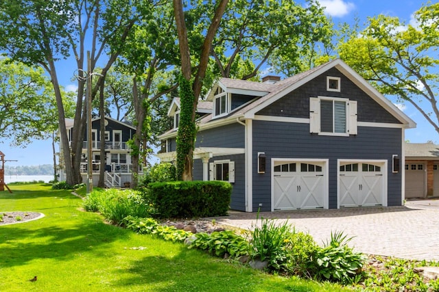 8823 406th Ave, Genoa City, WI 53128 - view of front of house with a front yard, decorative driveway, and a water view