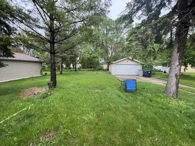 3668 S 79th St, Milwaukee, WI 53220 - view of grassy yard featuring an outdoor structure and a detached garage