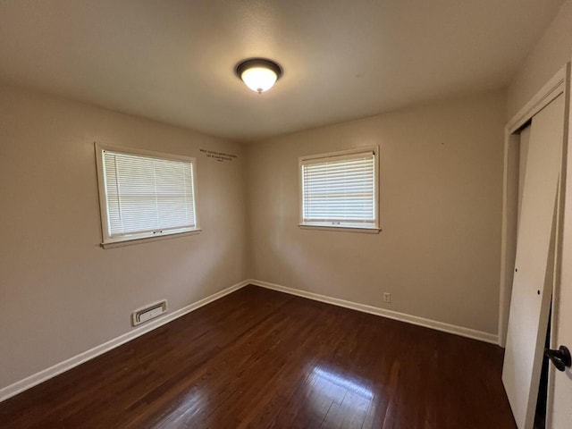 3668 S 79th St, Milwaukee, WI 53220 - unfurnished bedroom with dark wood-type flooring and a closet