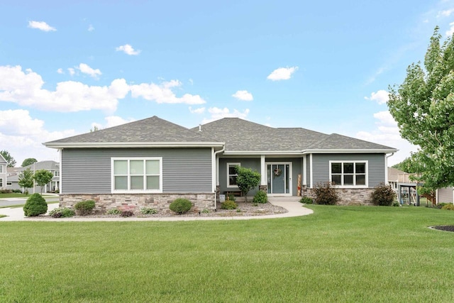 4790 Innovation Dr, Deforest, WI 53532 - view of front of home featuring stone siding, a front lawn, and a shingled roof
