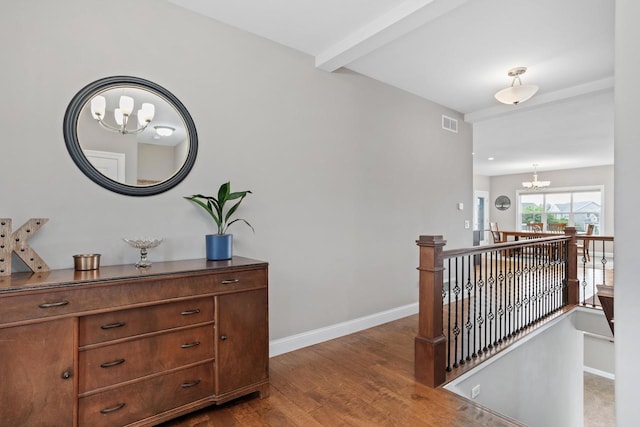 4790 Innovation Dr, Deforest, WI 53532 - hallway with an upstairs landing, a chandelier, dark wood finished floors, and beamed ceiling