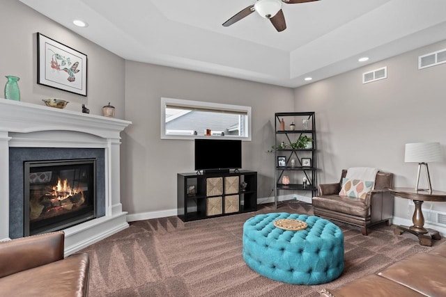 4790 Innovation Dr, Deforest, WI 53532 - sitting room featuring carpet flooring, a ceiling fan, recessed lighting, a glass covered fireplace, and a tray ceiling