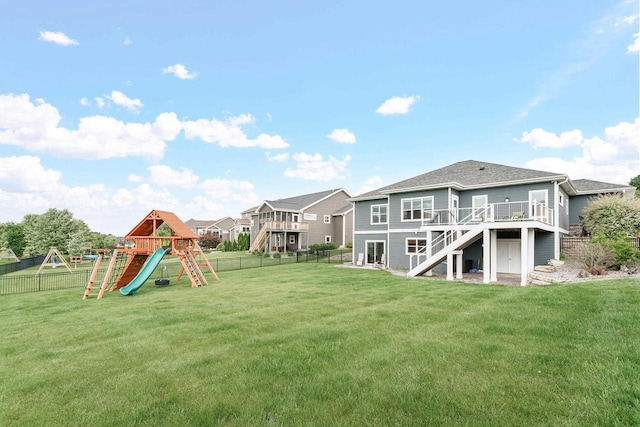 4790 Innovation Dr, Deforest, WI 53532 - rear view of property with stairs, a playground, a fenced backyard, a deck, and a shingled roof