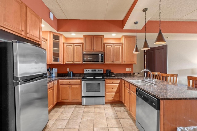 2411 River Rd Unit 2311, Wisconsin Dells, WI 53965 - kitchen with stainless steel appliances, a peninsula, dark stone counters, hanging light fixtures, and glass insert cabinets