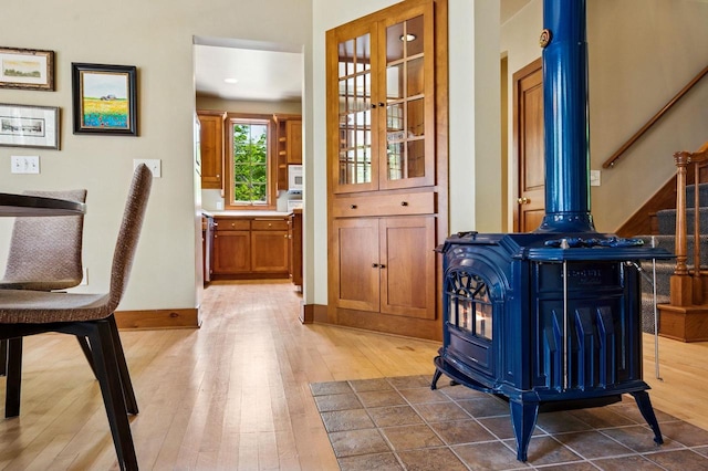1124 Garrett Bay Rd, Ellison Bay, WI 54210 - interior space with a wood stove, wood finished floors, and stairway