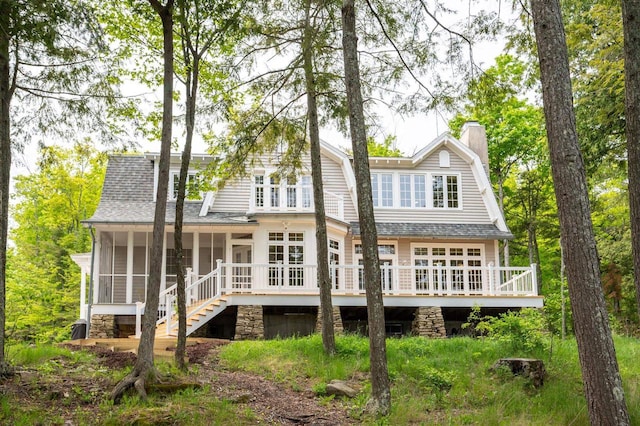 1124 Garrett Bay Rd, Ellison Bay, WI 54210 - rear view of house with a gambrel roof, a sunroom, a shingled roof, a deck, and a chimney