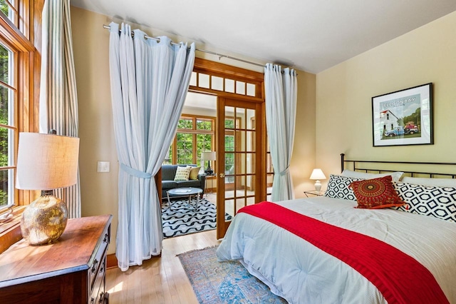 1124 Garrett Bay Rd, Ellison Bay, WI 54210 - bedroom with french doors and light wood-style flooring