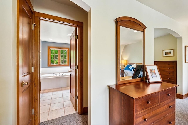 1124 Garrett Bay Rd, Ellison Bay, WI 54210 - corridor featuring light carpet, arched walkways, and light tile patterned floors