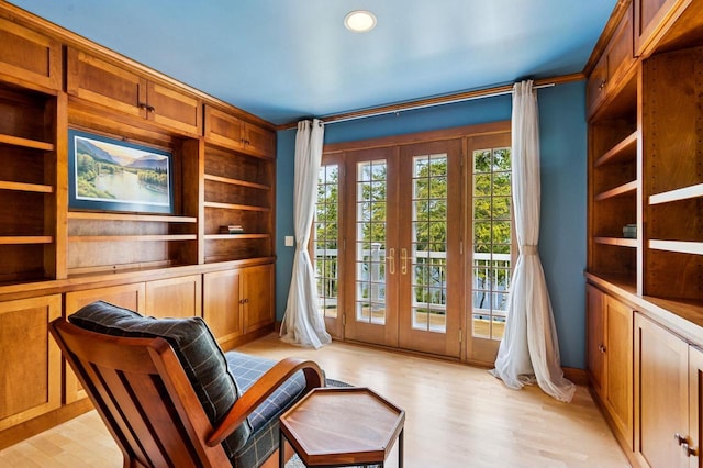 1124 Garrett Bay Rd, Ellison Bay, WI 54210 - unfurnished room featuring french doors, light wood-style floors, and built in features