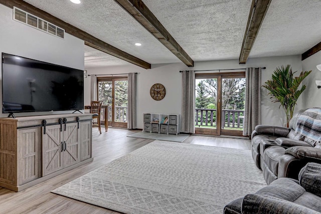 N9695 Willard Rd, Berlin, WI 54923 - living area with light wood finished floors, beamed ceiling, recessed lighting, and a textured ceiling