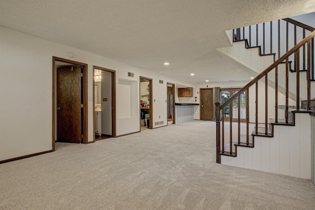 N9695 Willard Rd, Berlin, WI 54923 - unfurnished living room featuring light carpet, a textured ceiling, stairs, and recessed lighting