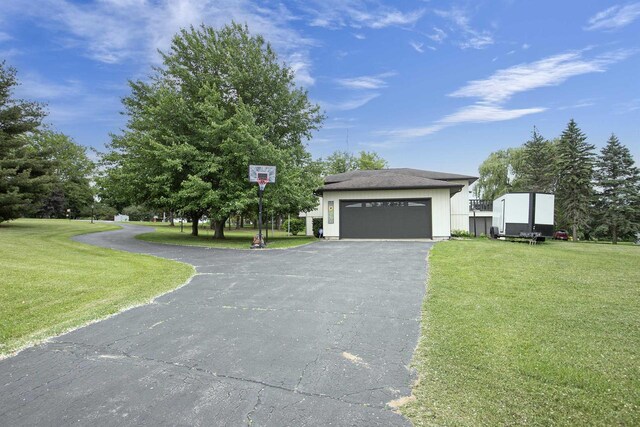 N9695 Willard Rd, Berlin, WI 54923 - view of front facade with driveway, a front yard, and an attached garage