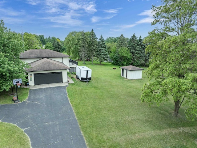 N9695 Willard Rd, Berlin, WI 54923 - view of green lawn with a storage shed, a garage, and driveway