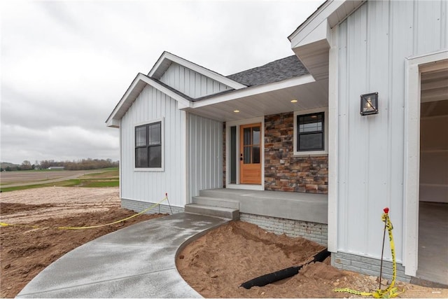 397 Candy Ln, River Falls, WI 54022 - view of exterior entry featuring board and batten siding and a shingled roof