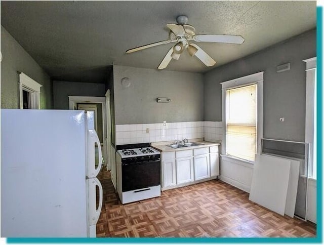 3623 N 1st St Unit 3623A, Milwaukee, WI 53212 - kitchen with white appliances, white cabinets, a ceiling fan, decorative backsplash, and light countertops