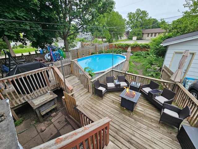 152 Hoyt St, Fond Du Lac, WI 54935 - view of pool featuring a deck, a fenced backyard, and an outdoor living space with a fire pit