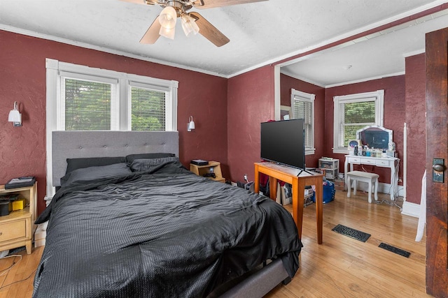 152 Hoyt St, Fond Du Lac, WI 54935 - bedroom with light wood finished floors, multiple windows, crown molding, a textured wall, and a ceiling fan
