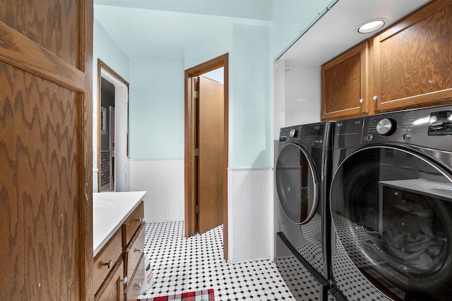 152 Hoyt St, Fond Du Lac, WI 54935 - laundry area featuring cabinet space, washer and clothes dryer, wainscoting, and light flooring