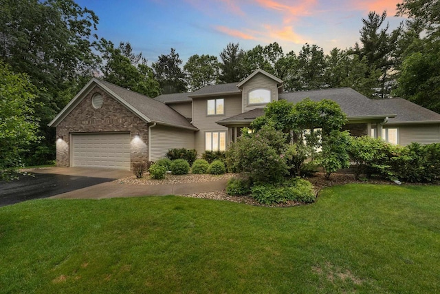 2621 Russet Dr, Plover, WI 54467 - view of front facade featuring a garage, asphalt driveway, a front yard, view of scattered trees, and a shingled roof